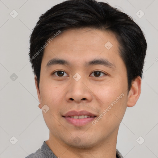 Joyful asian young-adult male with short  brown hair and brown eyes