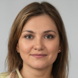 Joyful white young-adult female with medium  brown hair and brown eyes