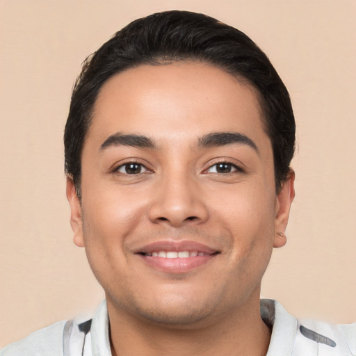 Joyful latino young-adult male with short  black hair and brown eyes