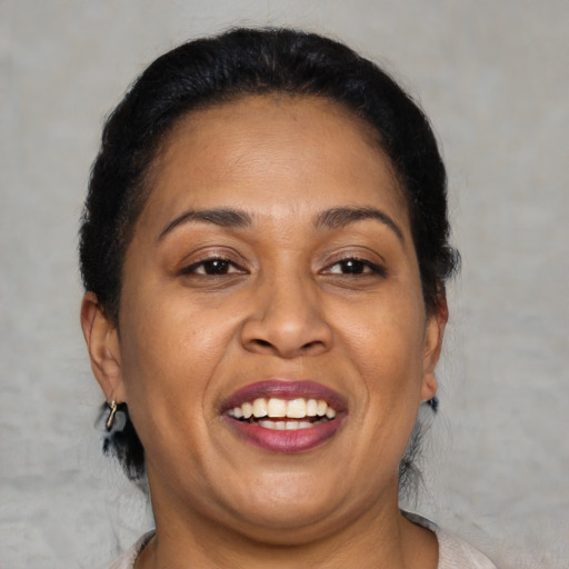 Joyful latino adult female with short  brown hair and brown eyes