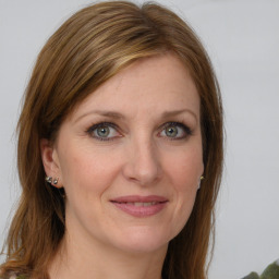 Joyful white young-adult female with long  brown hair and green eyes