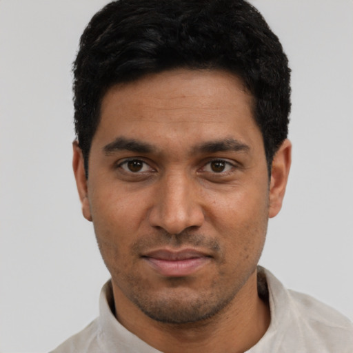 Joyful latino young-adult male with short  black hair and brown eyes