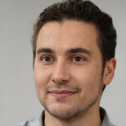 Joyful white adult male with short  brown hair and brown eyes