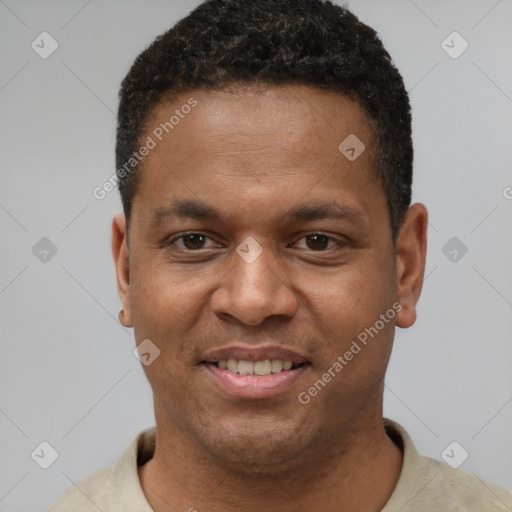 Joyful black young-adult male with short  black hair and brown eyes