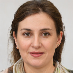 Joyful white adult female with medium  brown hair and brown eyes