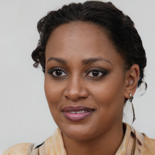 Joyful black young-adult female with long  brown hair and brown eyes