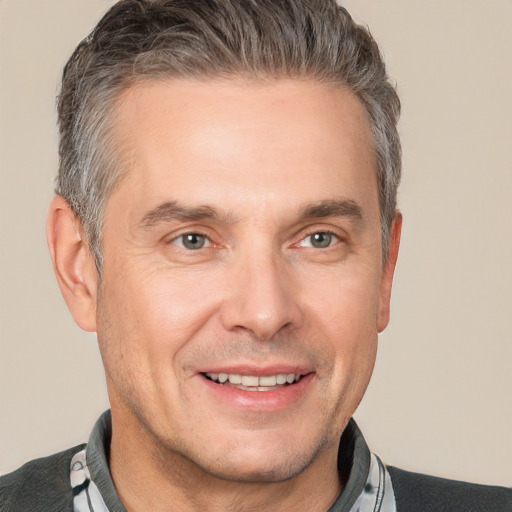 Joyful white adult male with short  brown hair and brown eyes