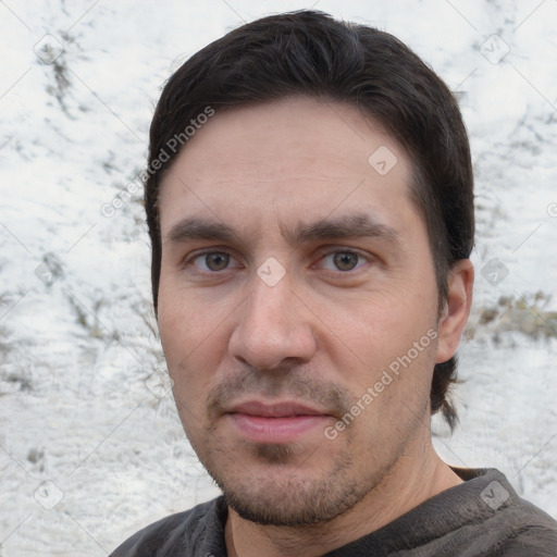 Joyful white adult male with short  brown hair and brown eyes