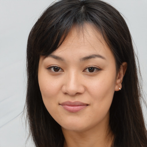 Joyful asian young-adult female with long  brown hair and brown eyes
