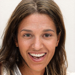 Joyful white adult female with long  brown hair and brown eyes