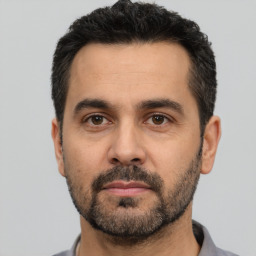 Neutral white adult male with short  black hair and brown eyes