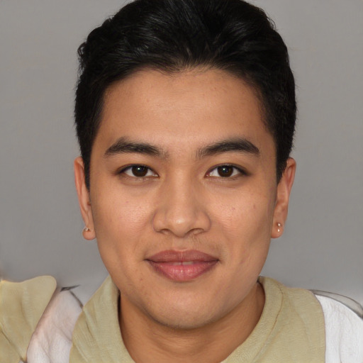Joyful latino young-adult male with short  brown hair and brown eyes