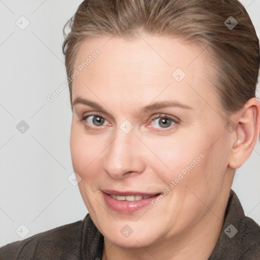 Joyful white adult female with short  brown hair and grey eyes