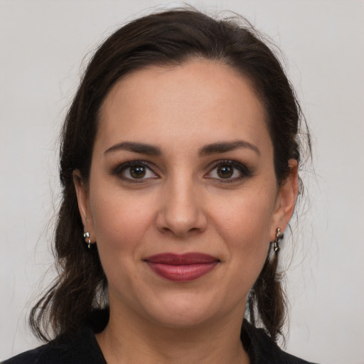 Joyful white young-adult female with medium  brown hair and brown eyes