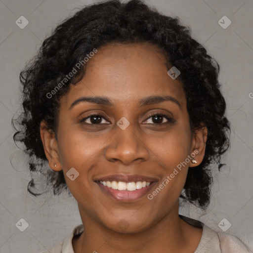 Joyful black young-adult female with long  brown hair and brown eyes