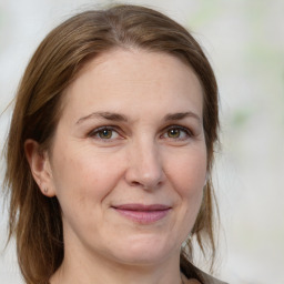 Joyful white adult female with medium  brown hair and brown eyes