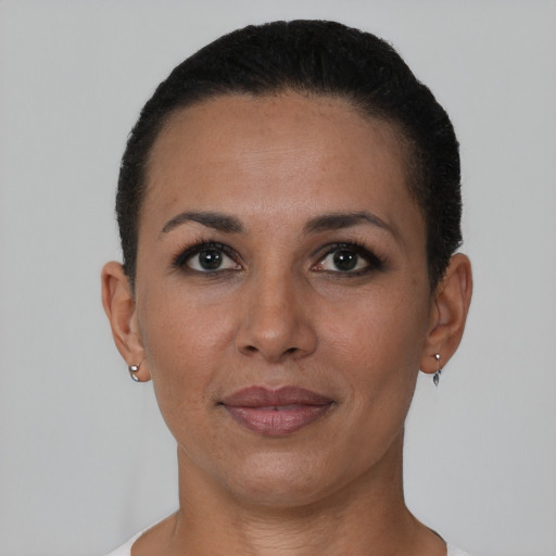 Joyful black adult female with short  black hair and brown eyes