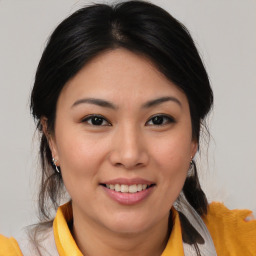 Joyful asian young-adult female with medium  brown hair and brown eyes