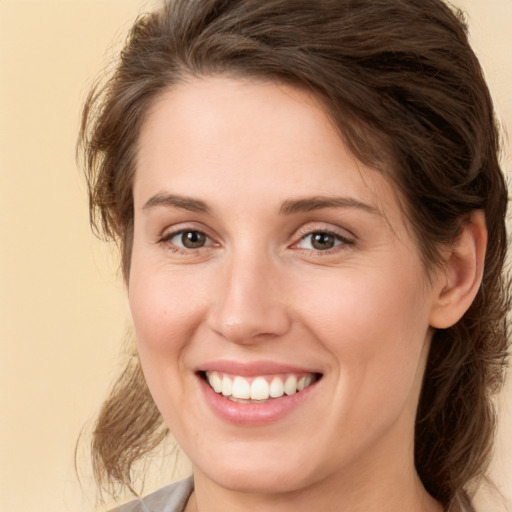 Joyful white young-adult female with medium  brown hair and brown eyes