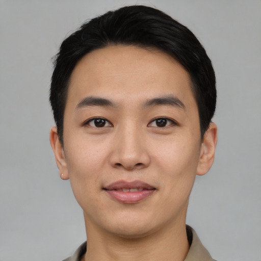Joyful asian young-adult male with short  black hair and brown eyes