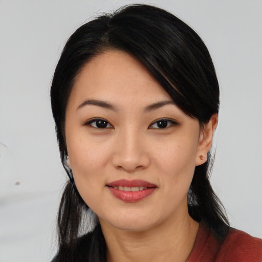 Joyful asian young-adult female with medium  black hair and brown eyes