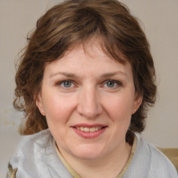 Joyful white young-adult female with medium  brown hair and blue eyes