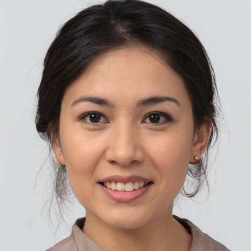 Joyful white young-adult female with medium  brown hair and brown eyes