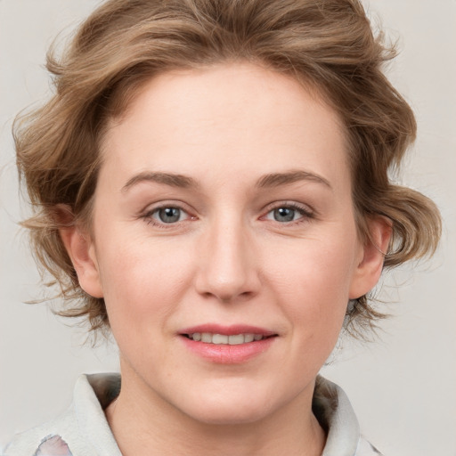 Joyful white young-adult female with medium  brown hair and blue eyes