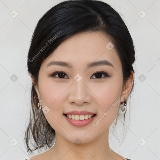 Joyful asian young-adult female with medium  black hair and brown eyes