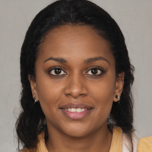 Joyful black young-adult female with medium  brown hair and brown eyes