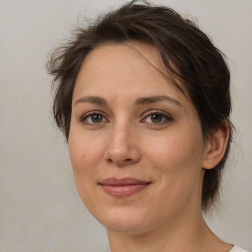 Joyful white adult female with medium  brown hair and brown eyes