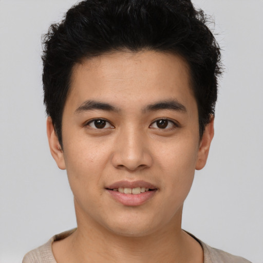 Joyful asian young-adult male with short  black hair and brown eyes