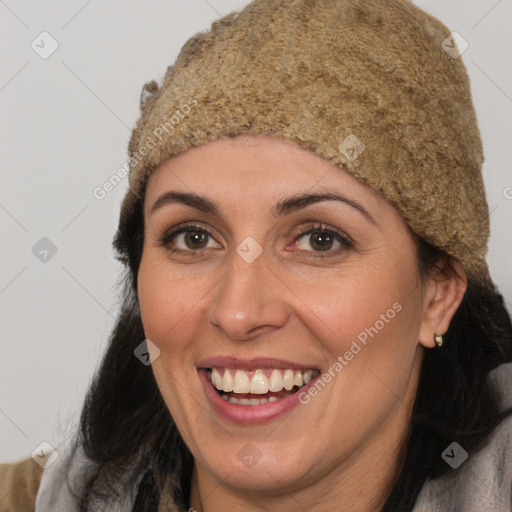 Joyful white adult female with long  brown hair and brown eyes