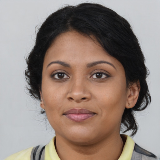 Joyful black young-adult female with medium  brown hair and brown eyes