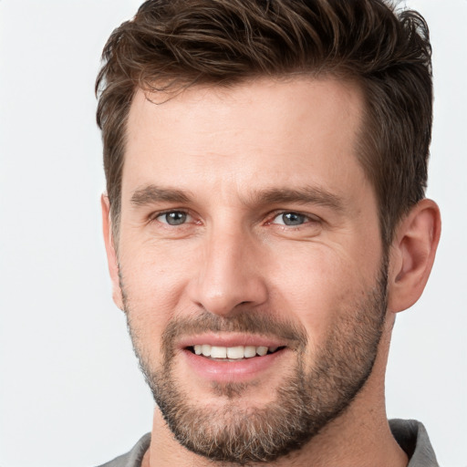 Joyful white young-adult male with short  brown hair and grey eyes