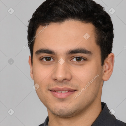 Joyful white young-adult male with short  black hair and brown eyes