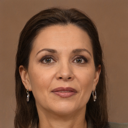 Joyful white adult female with long  brown hair and brown eyes