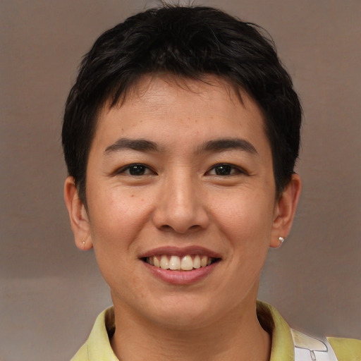 Joyful asian young-adult male with short  brown hair and brown eyes