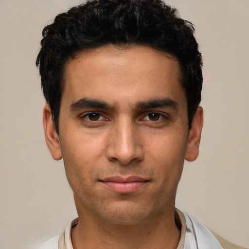 Joyful white young-adult male with short  black hair and brown eyes