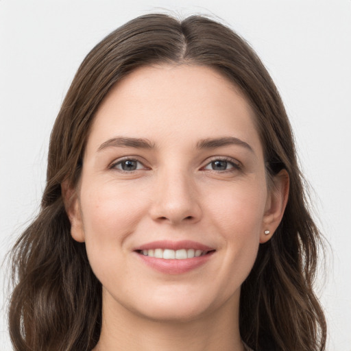 Joyful white young-adult female with long  brown hair and grey eyes