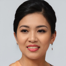 Joyful asian young-adult female with short  black hair and brown eyes