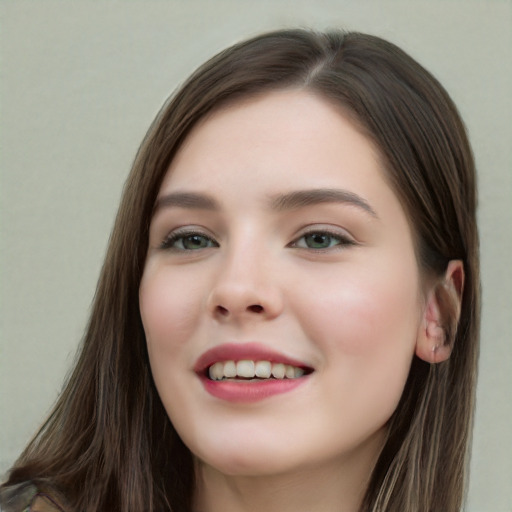 Joyful white young-adult female with long  brown hair and green eyes