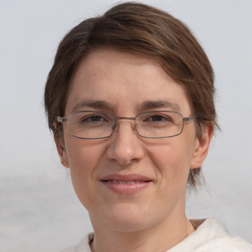 Joyful white adult female with short  brown hair and grey eyes