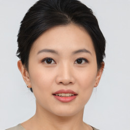 Joyful asian young-adult female with short  black hair and brown eyes