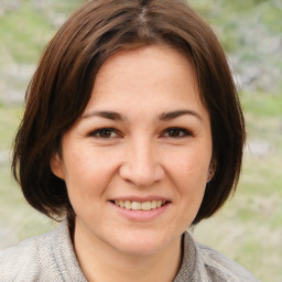 Joyful white young-adult female with medium  brown hair and brown eyes