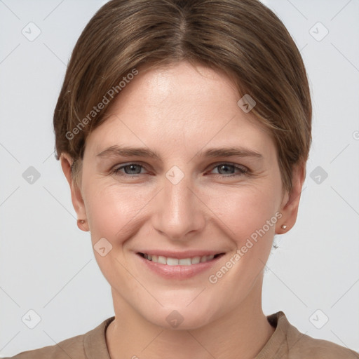 Joyful white young-adult female with short  brown hair and grey eyes