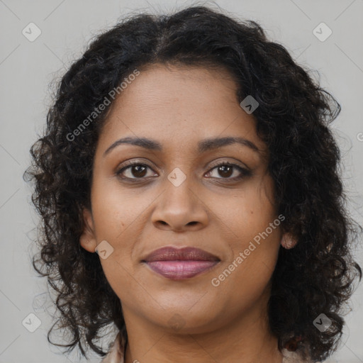 Joyful black young-adult female with long  brown hair and brown eyes