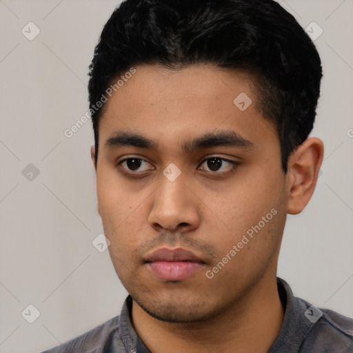 Neutral latino young-adult male with short  black hair and brown eyes