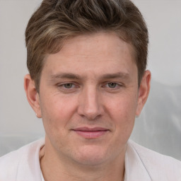 Joyful white adult male with short  brown hair and grey eyes