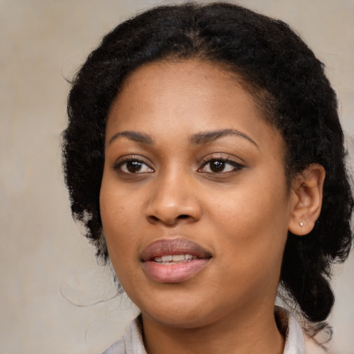 Joyful black young-adult female with medium  black hair and brown eyes